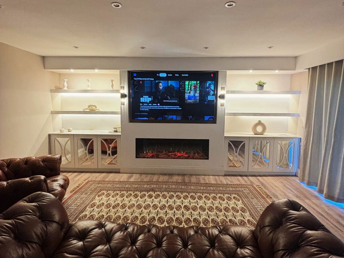 White built-in media wall with space for a television and shelving, fitted in Humberston