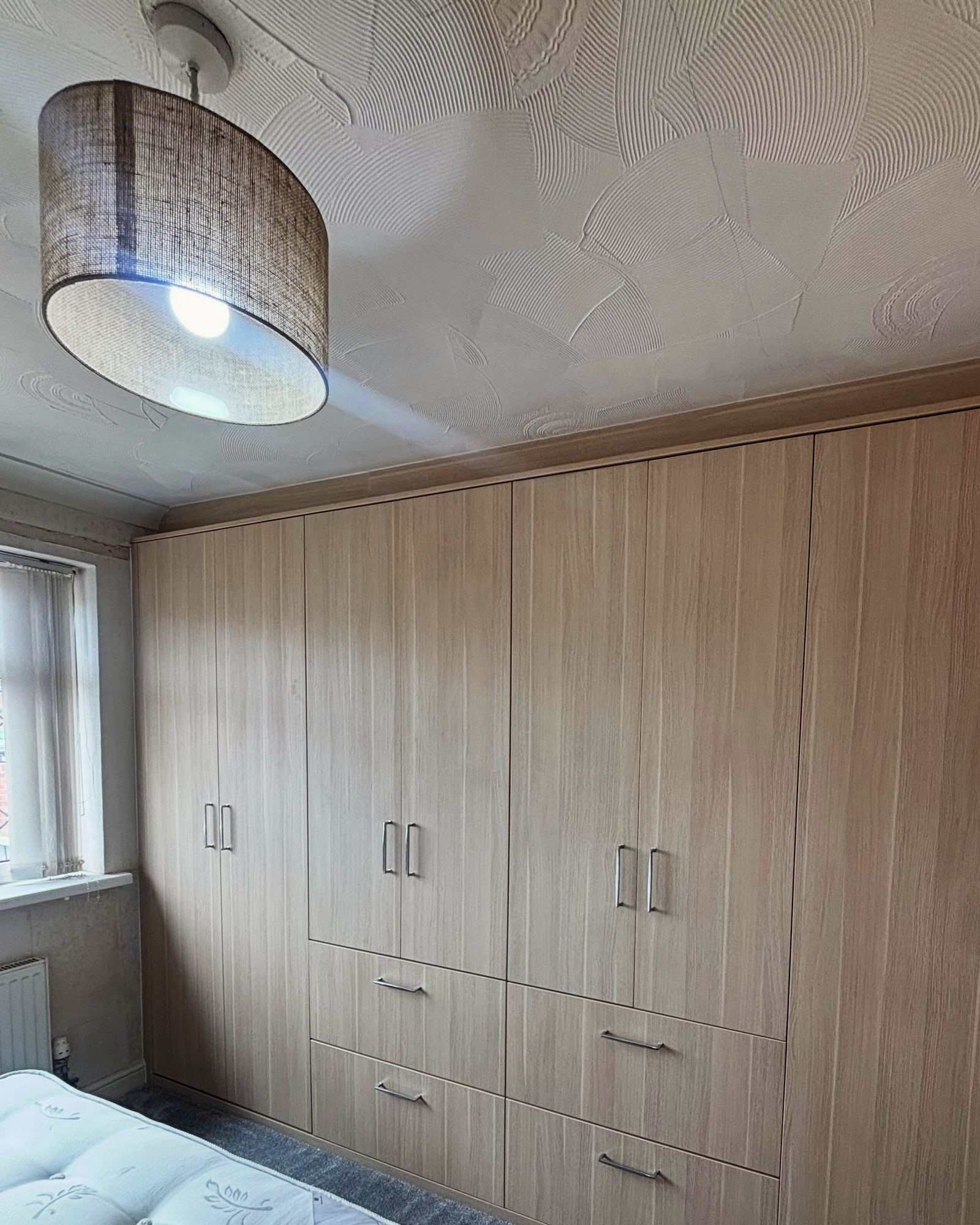 Wall-to-wall European Oak fitted wardrobes with new carpet and skirting