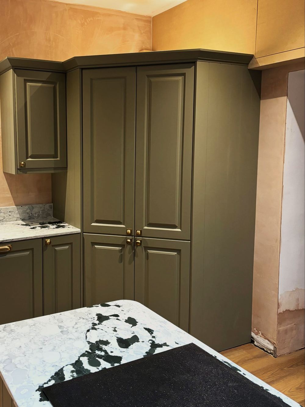 Olive green larder unit with brass pulls