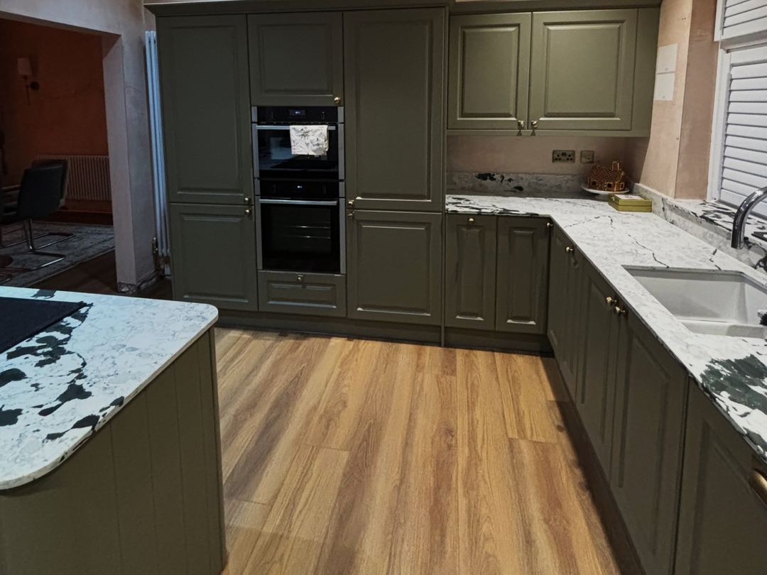 Olive green shaker kitchen with brass handles